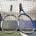 Tennis racquets rest against the net during Pioneer girls tennis teams practice Thursday night.
Courtney Sacco I AnnArbor.com